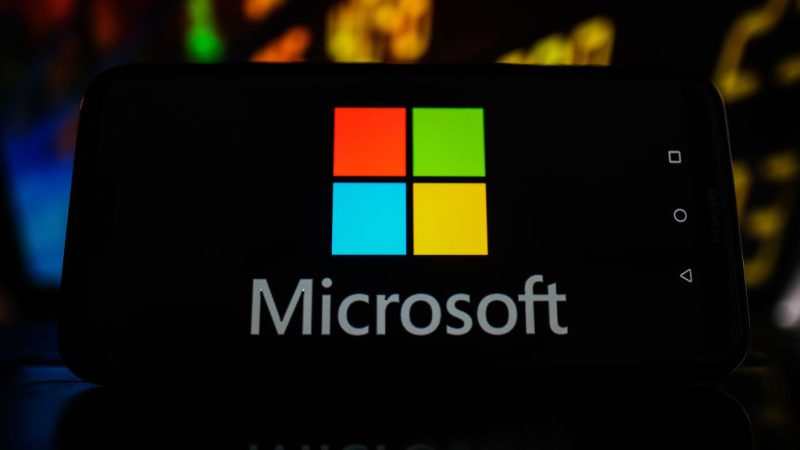 POLAND - 2021/02/19: In this photo illustration a Microsoft logo seen displayed on a smartphone with stock market values in the background. (Photo Illustration by Omar Marques/SOPA Images/LightRocket via Getty Images)